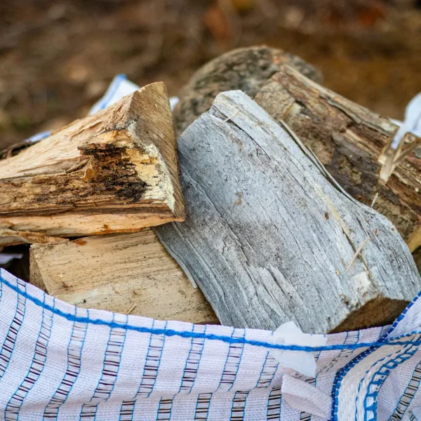 Close-up of a Barrow bag of air dried hardwood firewood for sale in Stowmarket